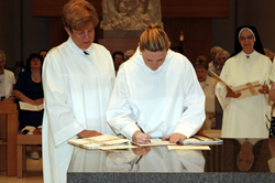 Heather signs documents